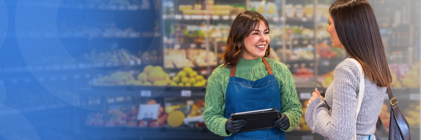 Retail worker helping a customer with a tablet
